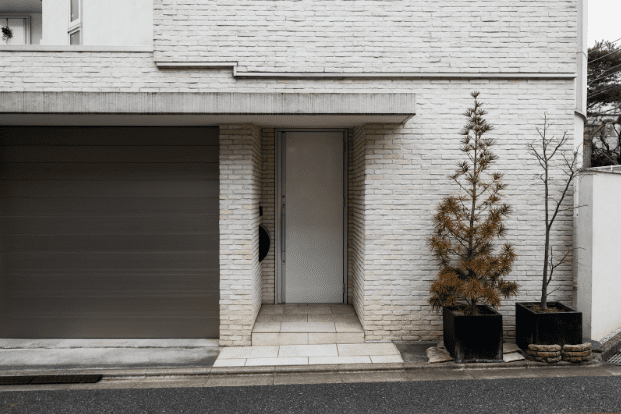 Modern insulated steel garage doors installed on a Santa Clarita home designed to withstand heat and dust — Archway Garage Doors