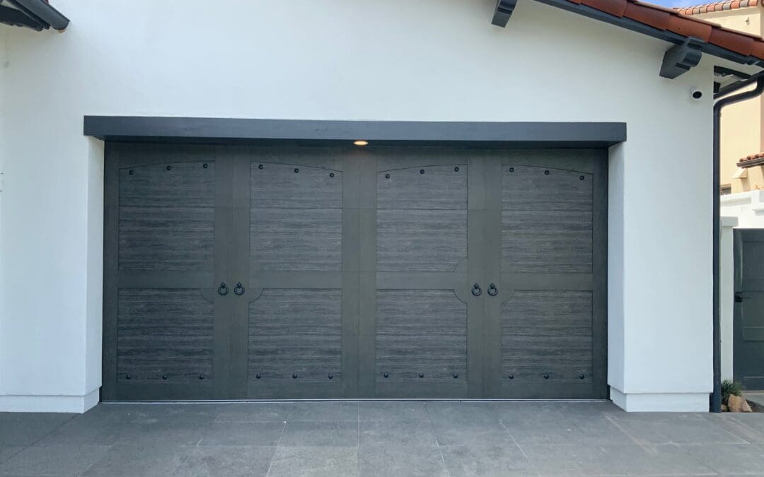 Modern garage door openers installation in a Stevenson Ranch home by Archway Garage Doors, featuring a sleek smart design integrated with durable blue torsion springs and heavy-duty tracks.