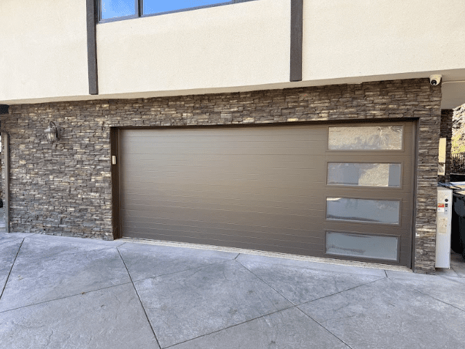 Insulated new garage doors installed in Castaic home improving energy efficiency and modern garage door opener performance